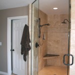 Master bath shower after with contemporary oil rubbed bronze and Travertine tile. 